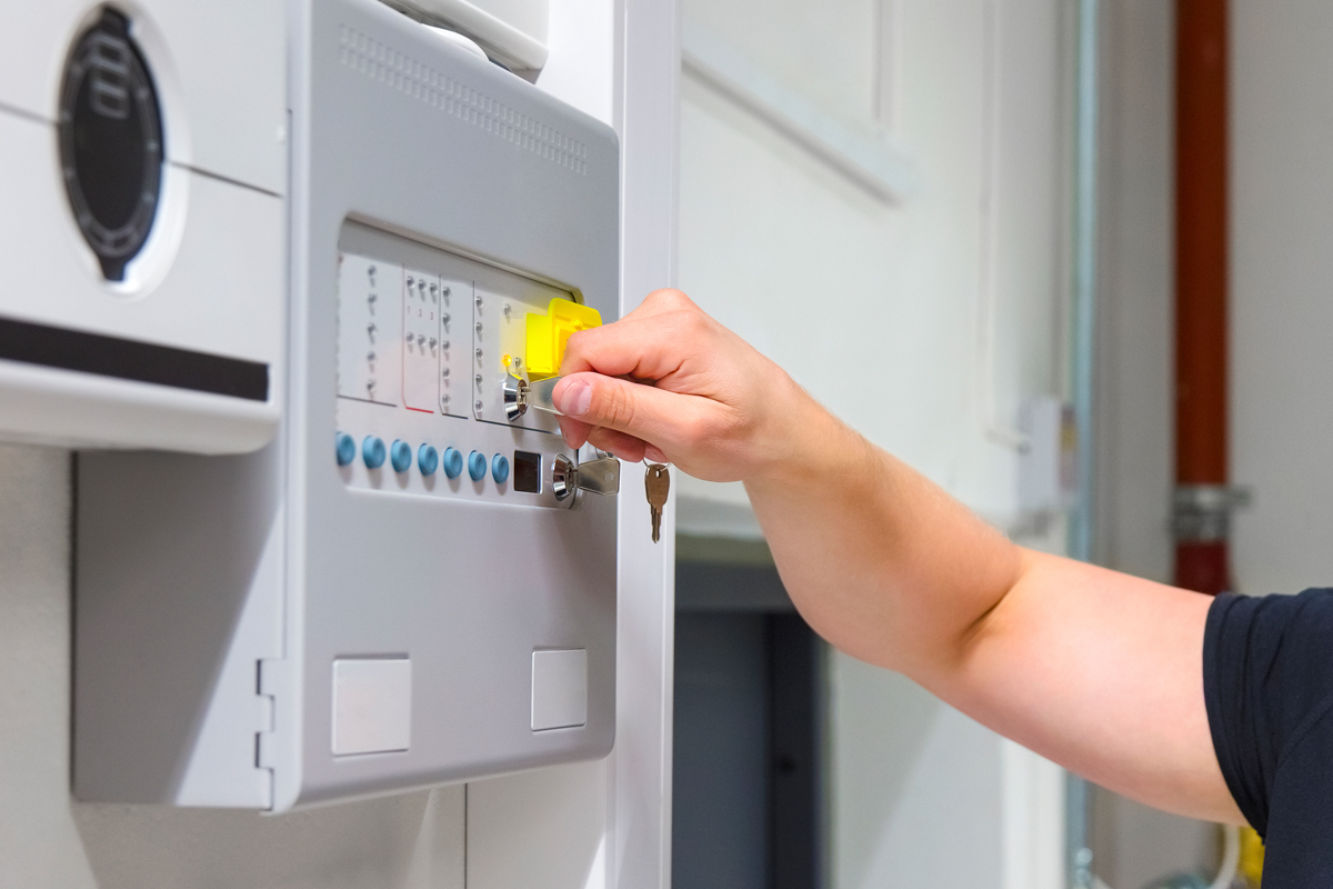 Close-up of Service Technician Opening Fire Panel In Server Room